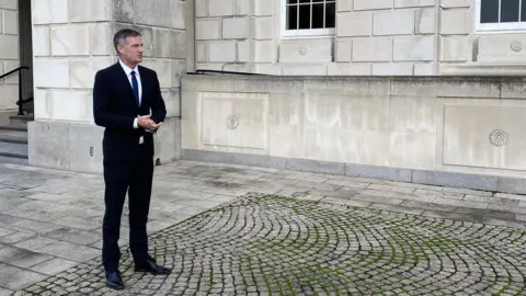 BBC Peter Kyle pictured standing outside Stormont