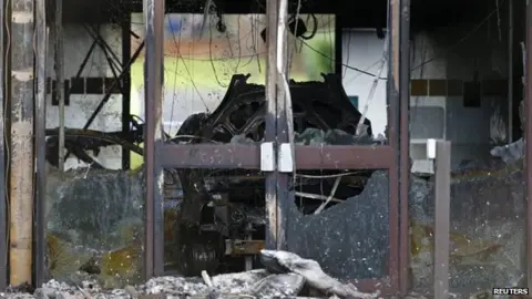 Reuters A burnt out car in the council building