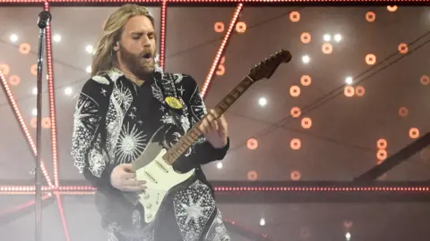 Getty Images Eurovision 2022 runner-up Sam Ryder plays the guitar on stage during his performance in Turin