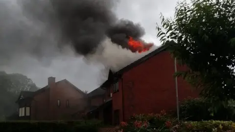 Jordan Marsh House roof on fire after lightning strike in Gowerton, Swansea