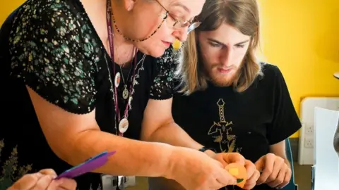 LDRS woman showing a man some creative arts