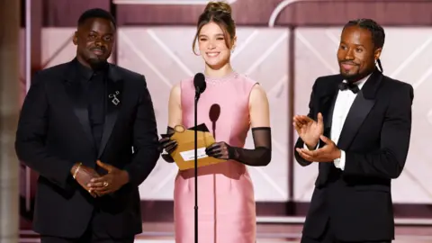 Getty Images Daniel Kaluuya, Hailee Steinfeld and Shameik Moore at the 81st Golden Globe Awards held at the Beverly Hilton in Beverly Hills, California on Sunday, January 7, 2024