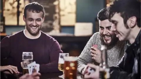 Getty Images Three men in the pub