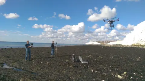 Dr John Barlow Dr Barlow (left) and Dr Jamie Gilham (right) launching a drone for sea cliff surveys