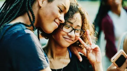 Getty Images Two teens taking a selfie