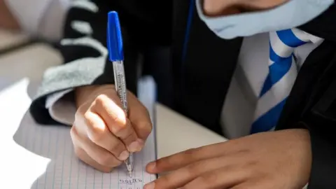 Getty Images Pupil wearing a face mask