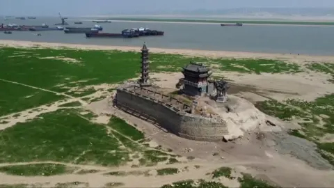 An aerial shot of a temple in China surrounded by the impact of the drought