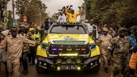 Getty Images Kenya's Deputy President and presidential candidatec (C) of Kenya Kwanza (Kenya first) political party coalition arrives in a car during his rally in Thika, Kenya on August 3, 2022 in Thika, Kenya