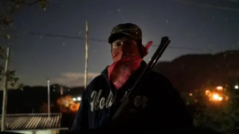 Reuters A community police agent, poses for a photo as he guards a check point in Ayahualtempa, Mexico, January 30, 2020.