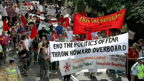 Getty Images People protest in Sydney over the "children overboard" affair