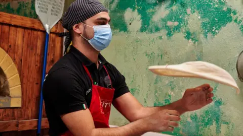 Getty Images Pizza restaurant worker in Lisbon