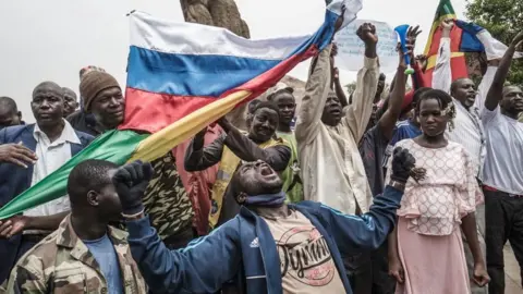 AFP Russians and Malian flags are waved by protesters in Bamako, during a demonstration against French influence in the country on May 27, 2021