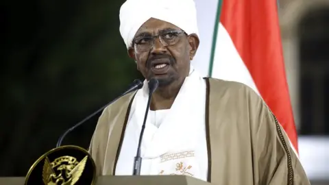 Getty Images Sudan's President Omar al-Bashir delivers a speech to the nation at the presidential palace in the capital Khartoum, 22 February 2019