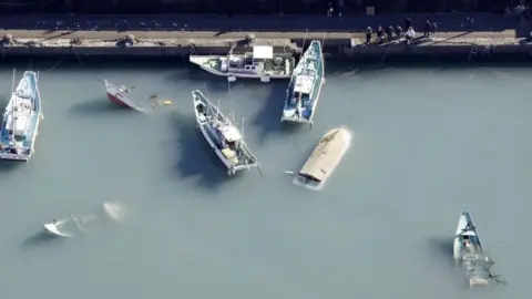 Kyodo via Reuters Capsized boats in Muroto, Kochi prefecture, Japan. Photo: 16 January 2022