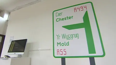 BBC A road sign showing the proposed spelling for Mold