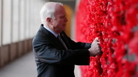 Reuters Senator John McCain places a poppy on the Roll of Honour wall during a visit to the Australian War Memorial in Canberra, Australia, May 29, 2017.