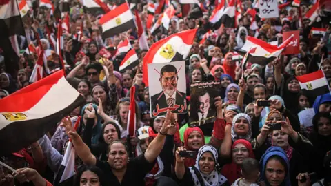 Getty Images Anti-Morsi supporters gather in Tahrir square to demand his resignation in nationwide protests.
