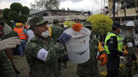 BBC Rubble is removed, bucket-by-bucket, as rescue workers try to clear a path to any survivors at Enrique Rébsamen school, Mexico City, 20 September 2017