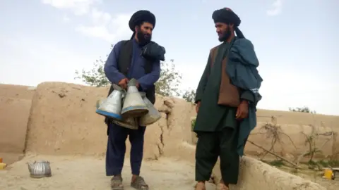 The Taliban mayor of Sangin, clutching petrol jugs