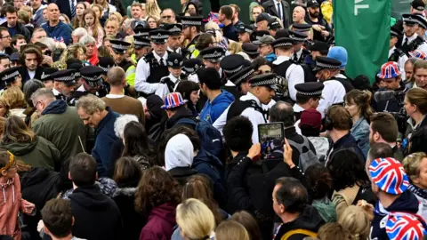 Reuters Protesters from climate protest group 'Just Stop Oil' are apprehended by police officers in the crowd