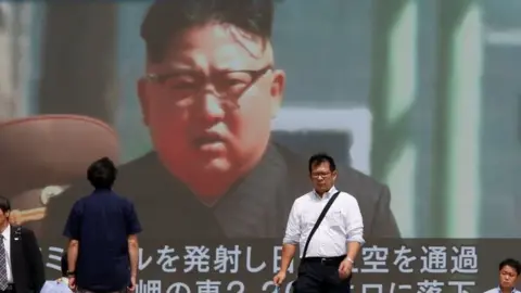 Reuters Passersby walk past a TV screen reporting news about North Korea's missile launch in Tokyo, Japan on 15 September 2017.