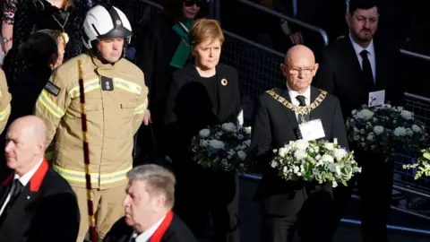 PA Media Lord Provost Robert Aldridge and First Minister Nicola Sturgeon arrive for the funeral