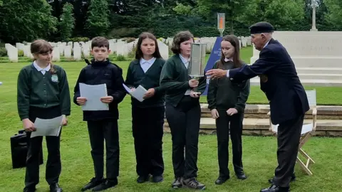 BBC/Naj Modak Children passing torch to veteran