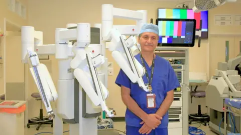 Wye Valley NHS Trust Consultant Mehmood Akhtar pictured with the new surgical robot