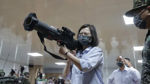 Taiwan Presidential Office A handout photo made available by the Taiwan Presidential office shows Taiwan President Tsai Ing-wen handling the Kestrel anti-armor rocket launcher during her visit inside a military base in Taoyuan city, Taiwan, 2 June 2022.