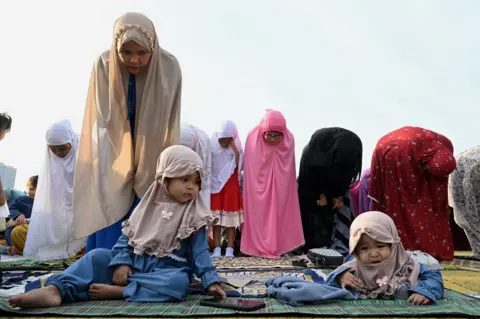 Jam Sta Rosa/AFP Muslims take part in a morning prayer celebrating the feast of Eid al-Adha at the Quirino Grandstand in Manila, Philippines