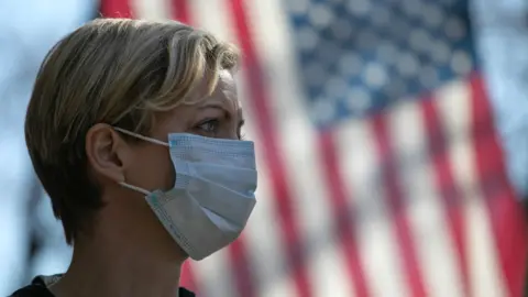 Getty Images Volunteer wearing mask in NYC