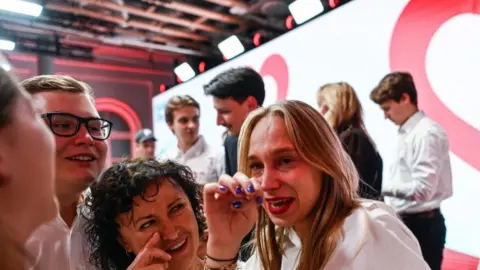 Omar Marques/Getty Images Supporters of the leader of Civic Coalition (KO), Donald Tusk celebrate the exit poll results during Poland's Parliamentary elections on October 15, 2023 in Warsaw, Poland