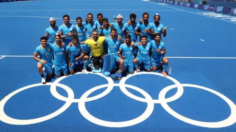 Getty Images Team India poses for a picture after winning the Men's Bronze medal match between Germany and India on day thirteen of the Tokyo 2020 Olympic Games