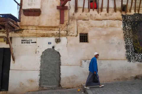 AFP A man walks down a street in the Casbah of Algiers on July 5, 2022.