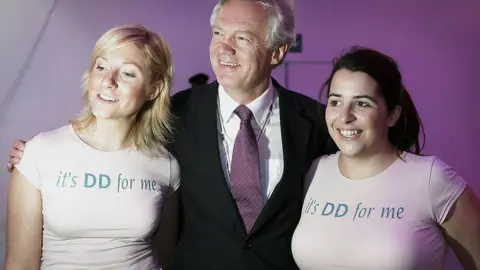 Getty Images David Davis pictured with two supporters wearing t-shirts emblazoned with "It's DD for me"