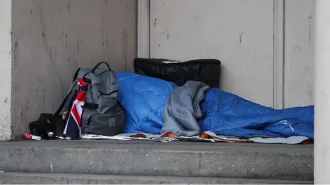 PA Media Homeless person sleeping in doorway