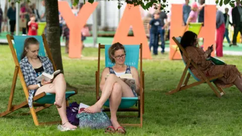 Getty Images Two women reading books at Hay