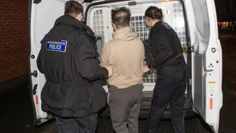 GMP A man being arrested and taken into the back of a GMP police wagon