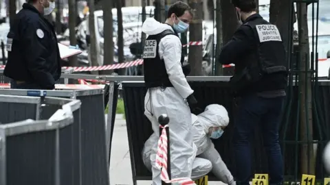 Getty Images Police investigate the scene of a shooting outside a Paris hospital on 12 April 2021