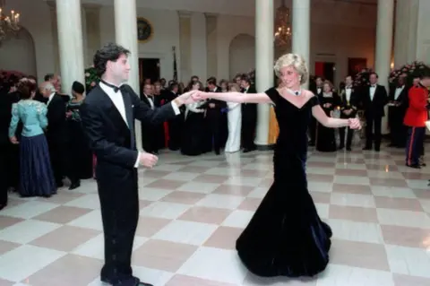 PA Princess Diana dances with John Travolta at the White House on 9 November 1985.