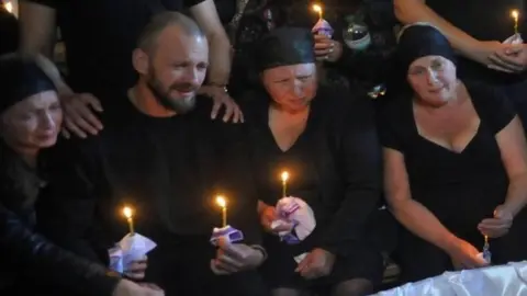 Reuters Mourners watch Liza's open casket at her funeral on Sunday