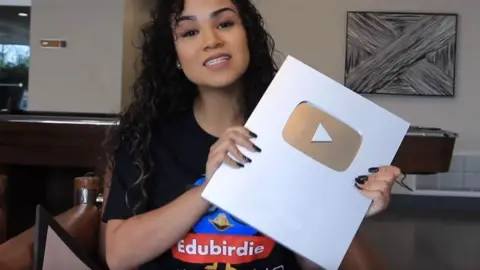 YouTube/sheismichaela Michaela Mendez wore the EduBirdie logo in a video in which she unboxes a YouTube award