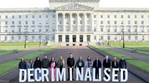 PAUL FAITH/getty Pro-choice supporters pose as they gather at Parliament buildings on the Stormont Estate in Belfast on 21 October 2019