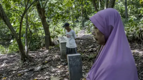 EPA Relatives visit the site that is believed to be the burial ground for victims of a 1965 massacre