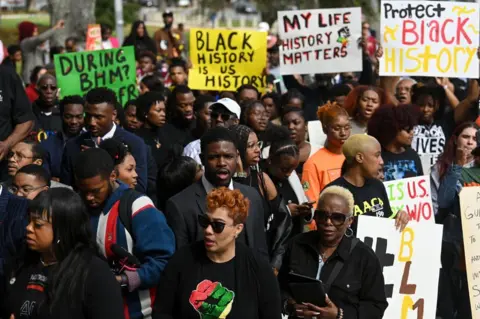 Getty Images Demonstrators protest against Governor DeSantis' plan to eliminate a high school course in African-American history