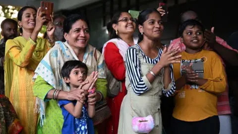 Getty Images People celebrate India's Moon landing