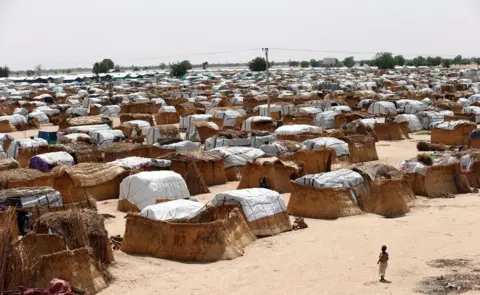 Reuters A girl walks through makeshift sheds at an internally displaced persons (IDP) camp on the outskirts of Maiduguri, northeast Nigeria June 6, 2017.