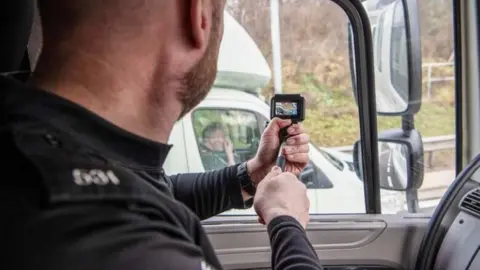 Northamptonshire Police Police officer travelling in an HGV cab films a lorry in the next lane