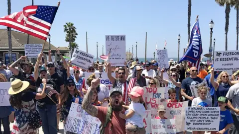 Getty Images Image shows protesters converged on Huntington Beach in May