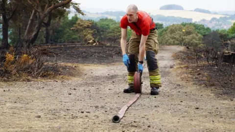 BBC/Claire Marshall Firefighter on Lickey Hills